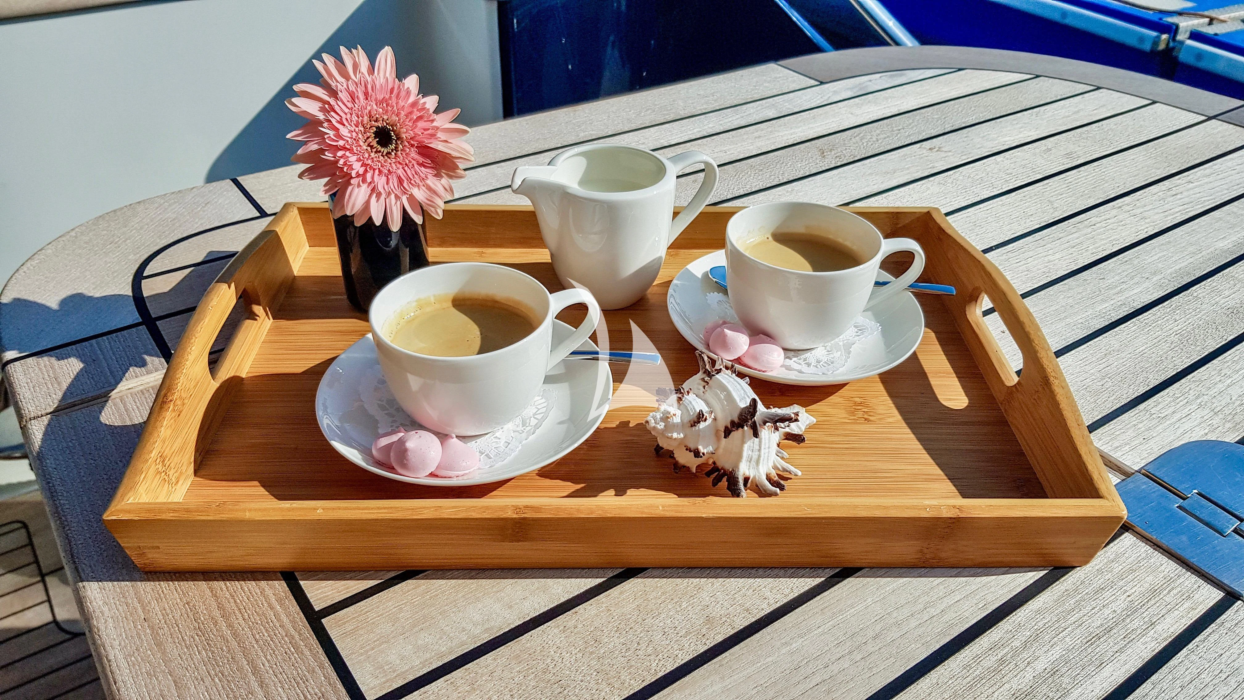 a table with cups and plates on it aboard BALTIC SEA Yacht for Sale