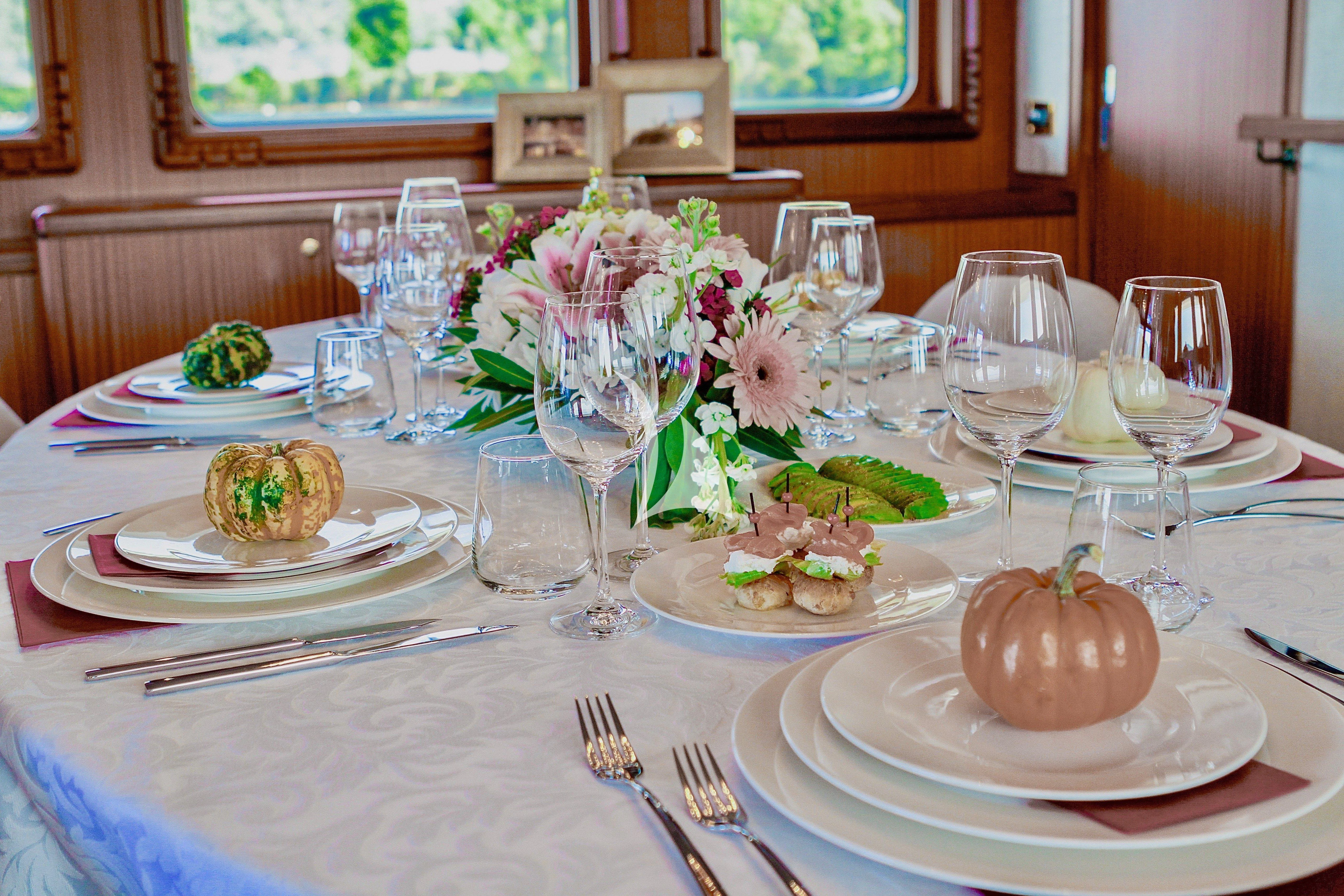 a table set with plates and glasses aboard BALTIC SEA Yacht for Sale
