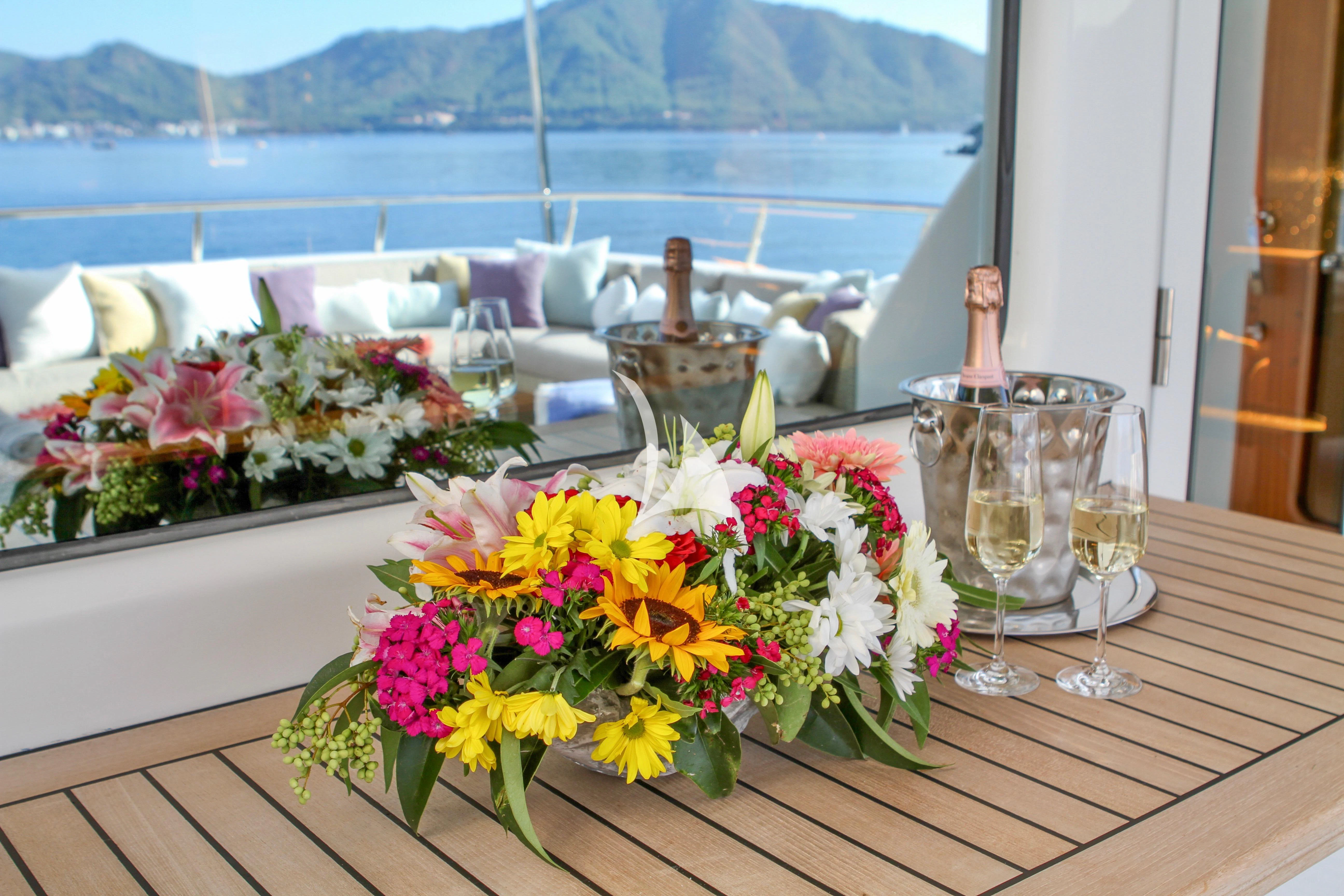 a table with flowers and wine glasses aboard BALTIC SEA Yacht for Sale