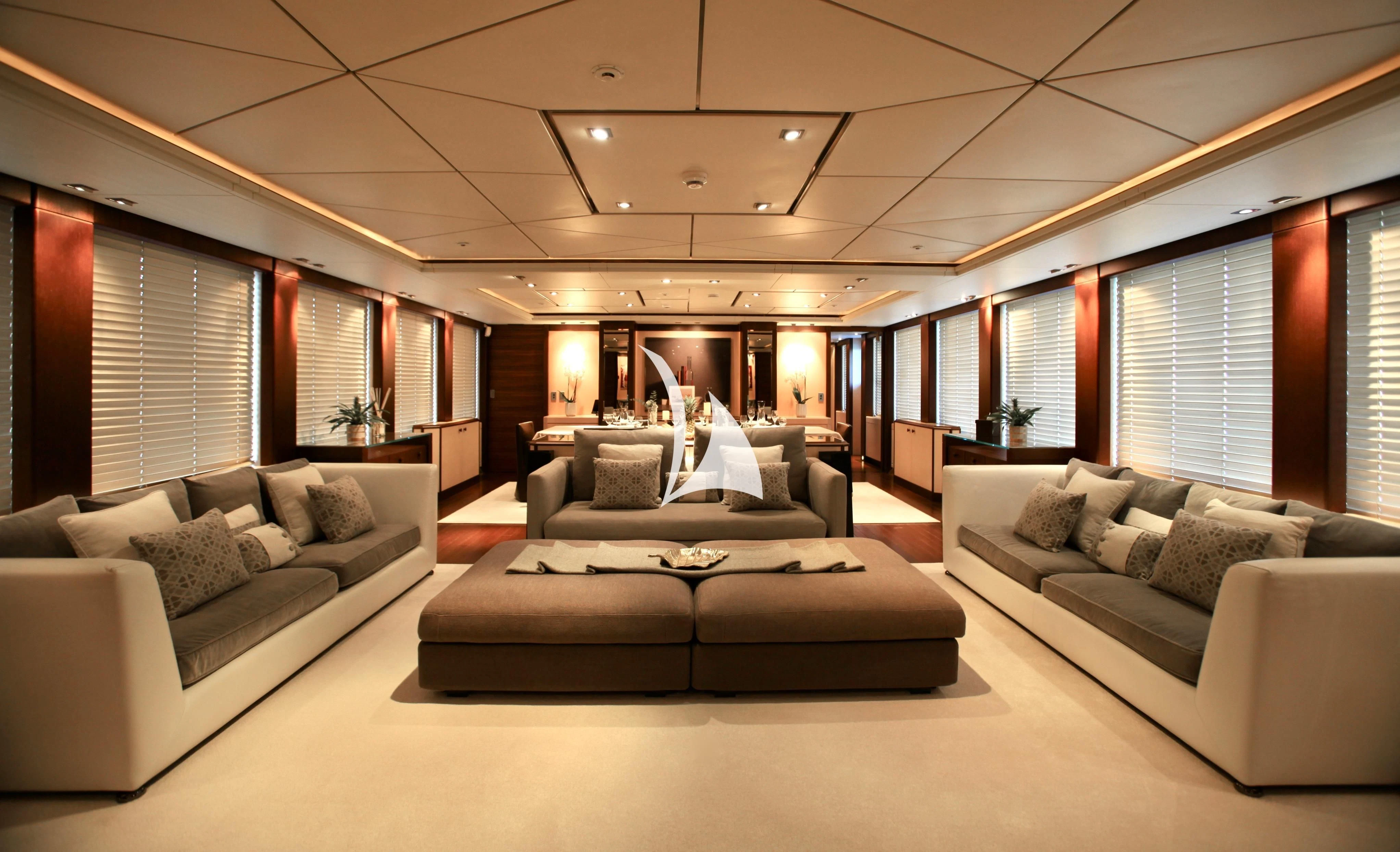 a person sitting on a couch in a large room aboard ALALYA Yacht for Sale