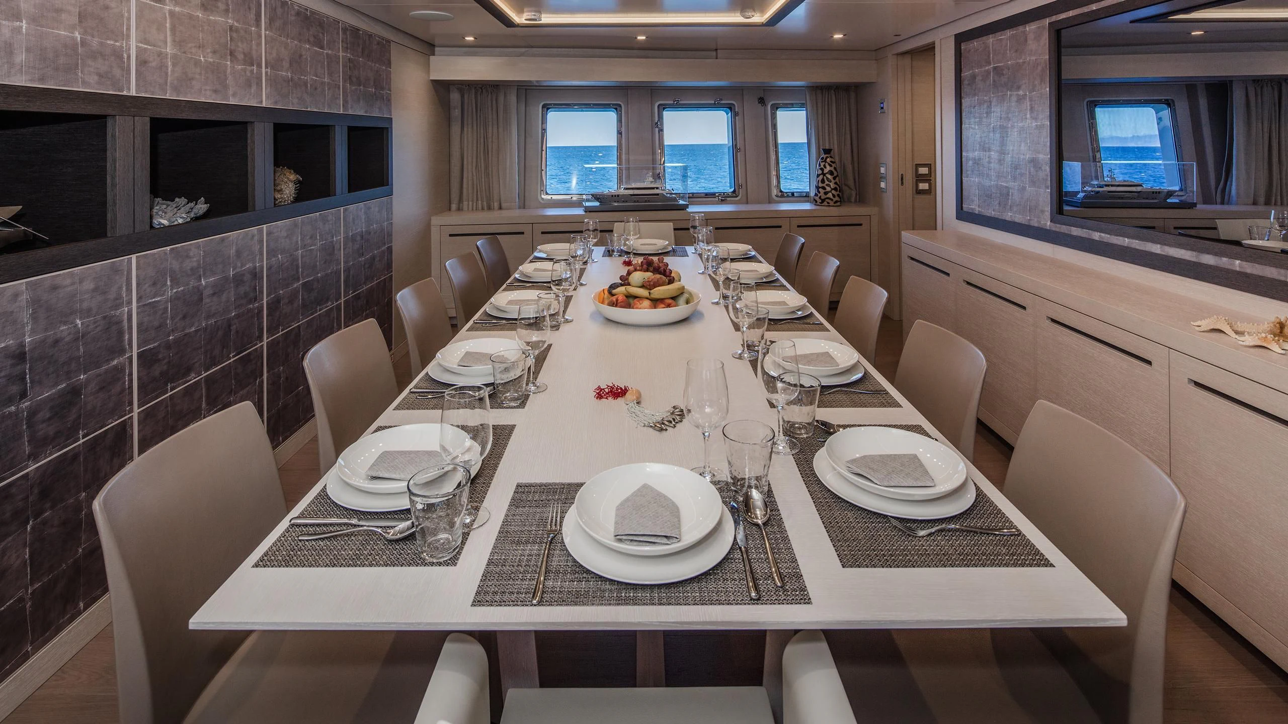 a table with plates and glasses on it aboard ALALYA Yacht for Sale