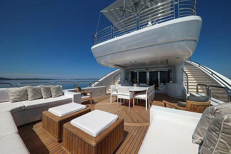 a living room with a large cruise ship in the background aboard ALALYA Yacht for Sale