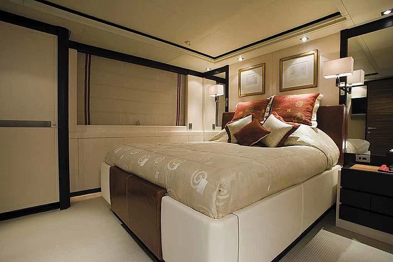 a bedroom with a bed and a mirror aboard ALALYA Yacht for Sale