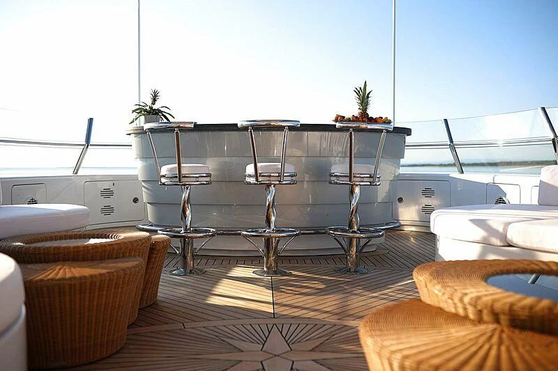 a kitchen with a table and chairs aboard ALALYA Yacht for Sale