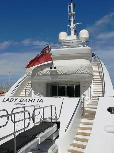 a white cruise ship with a red flag on the front aboard ALALYA Yacht for Sale