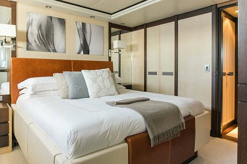 a bed with white sheets aboard ALALYA Yacht for Sale