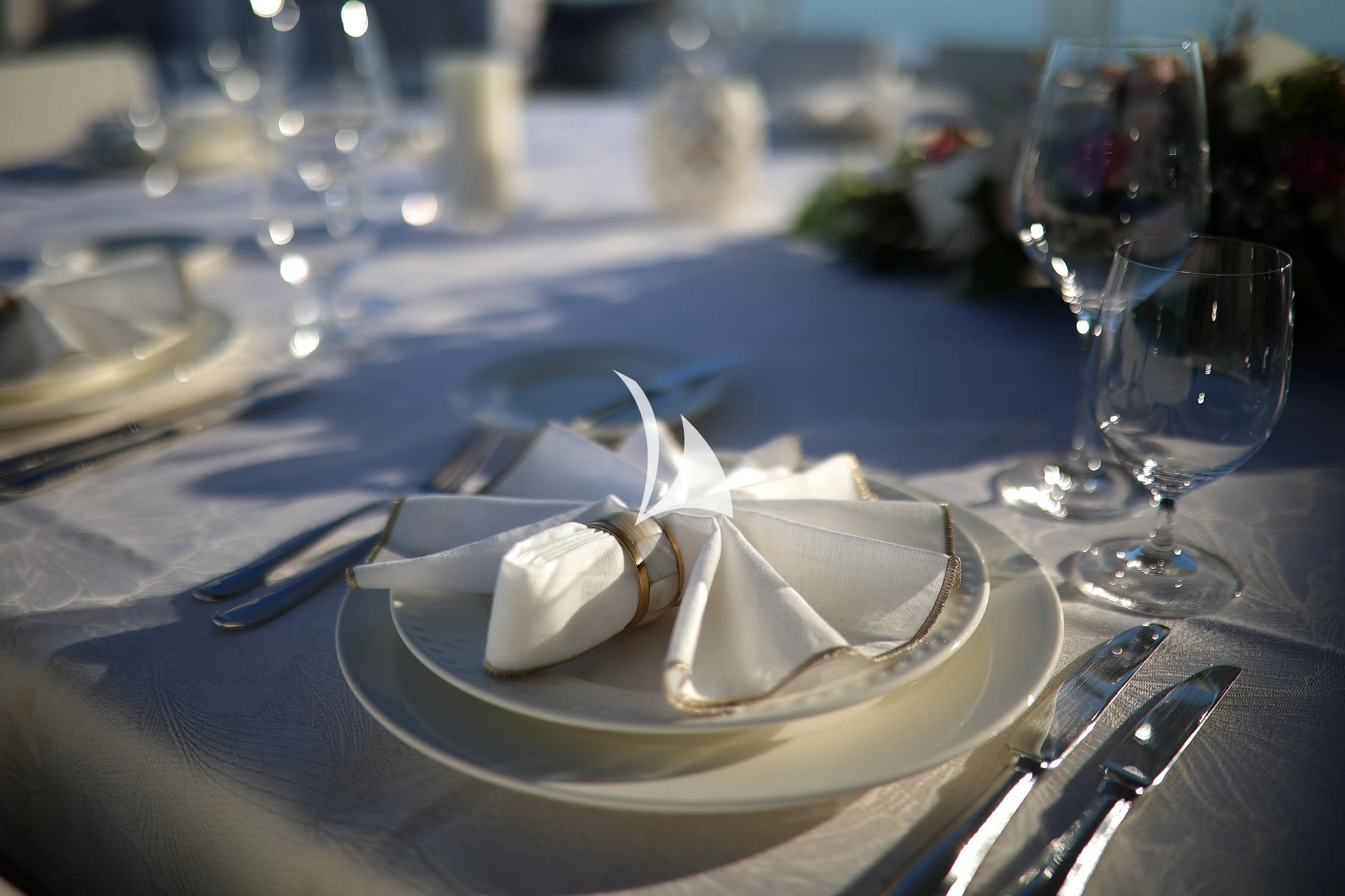 a plate of food and a glass of wine on a table aboard ALALYA Yacht for Sale