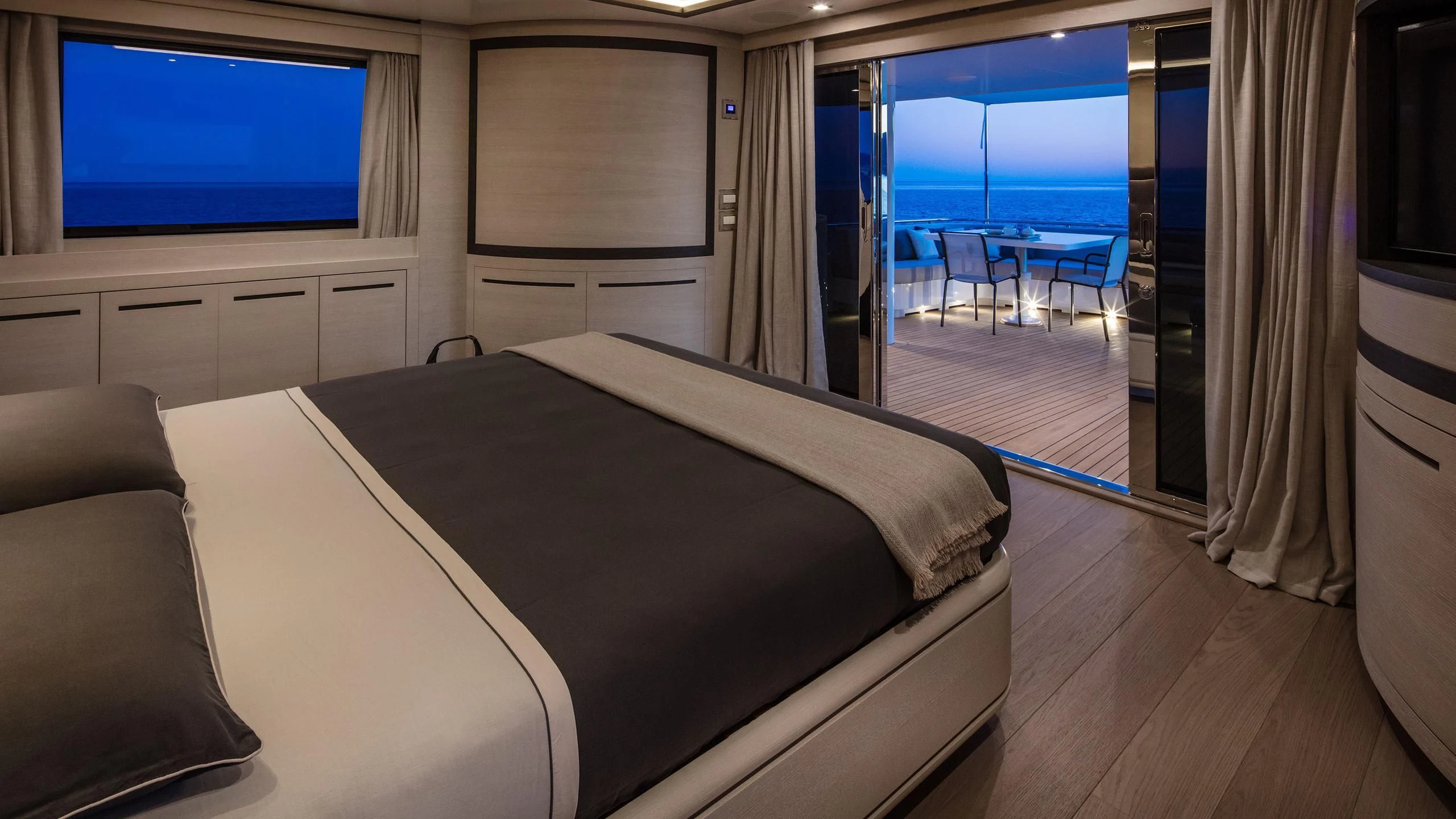 a room with a bed and a tv on the wall aboard ALALYA Yacht for Sale