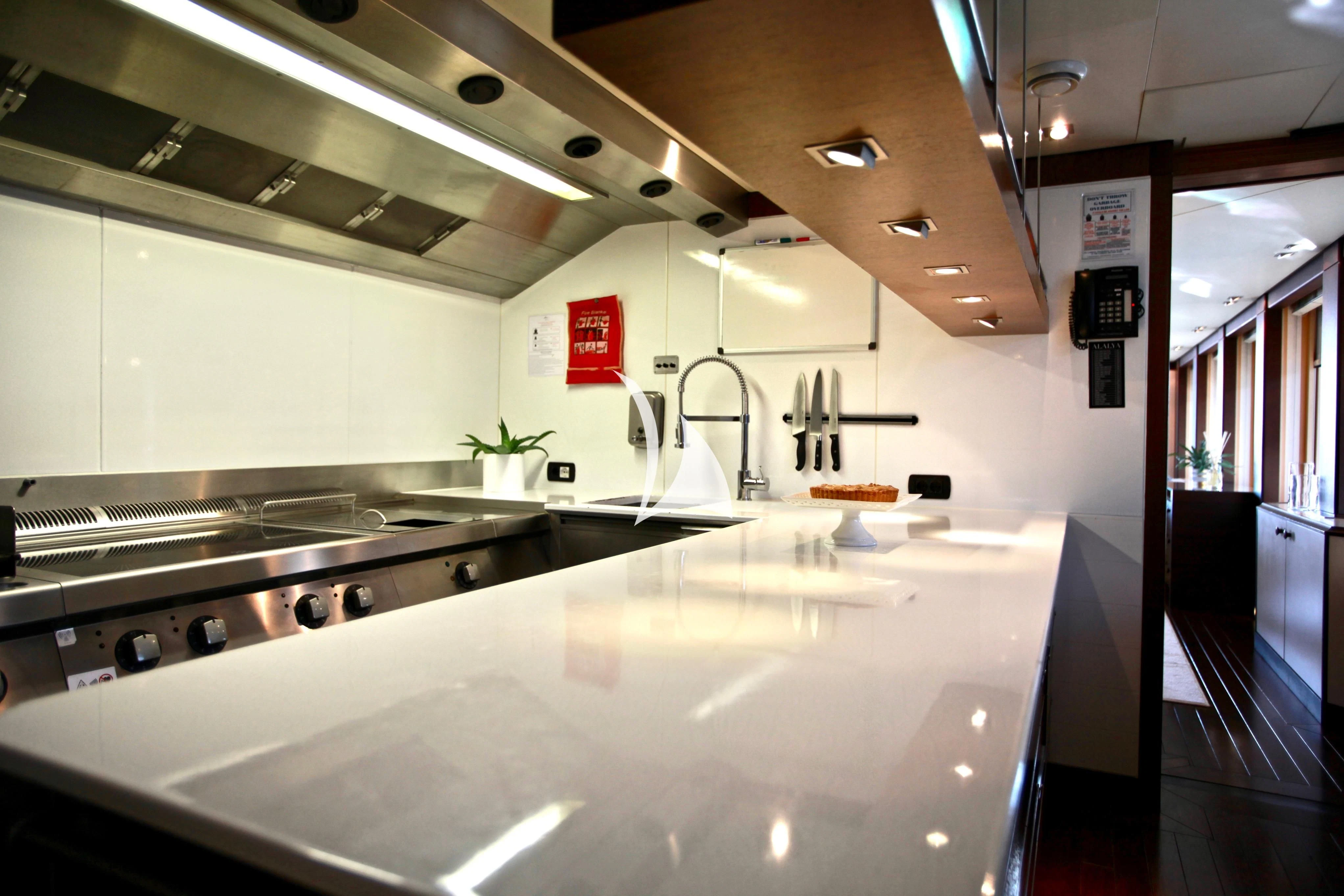 a kitchen with a large island aboard ALALYA Yacht for Sale