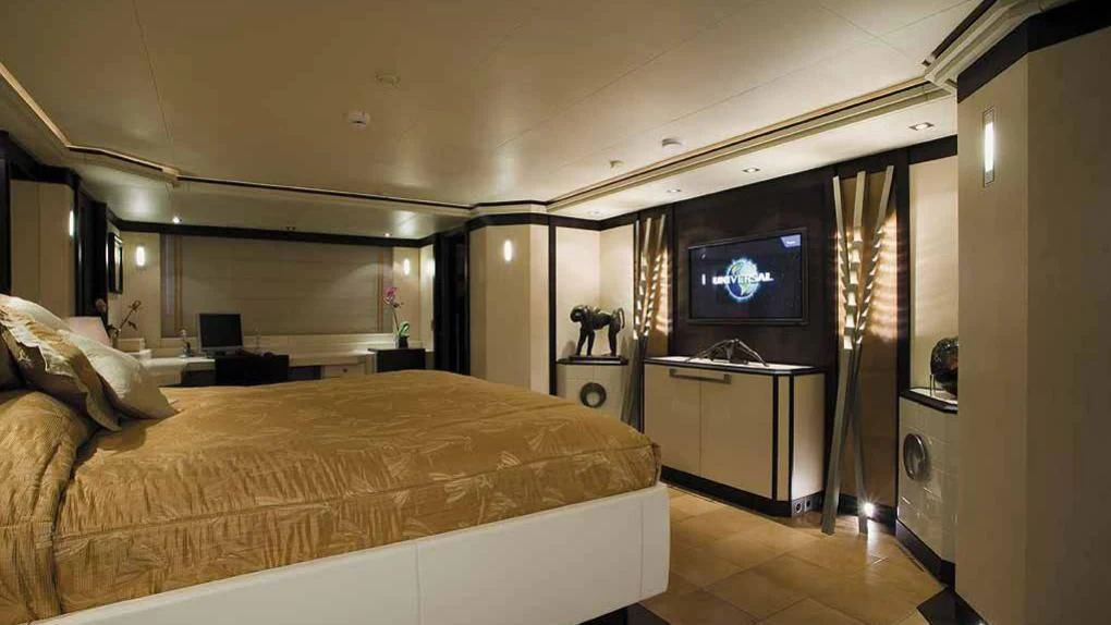 a bedroom with a bed and a tv on the wall aboard ALALYA Yacht for Sale