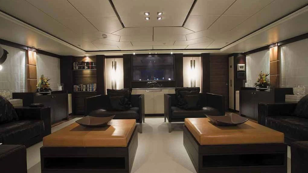 a room with leather couches and a table aboard ALALYA Yacht for Sale