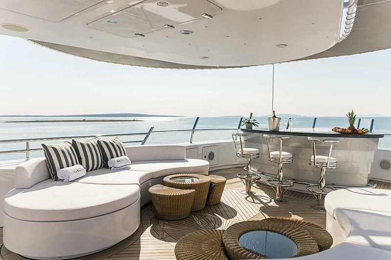 a room with a couch and a table and chairs aboard ALALYA Yacht for Sale
