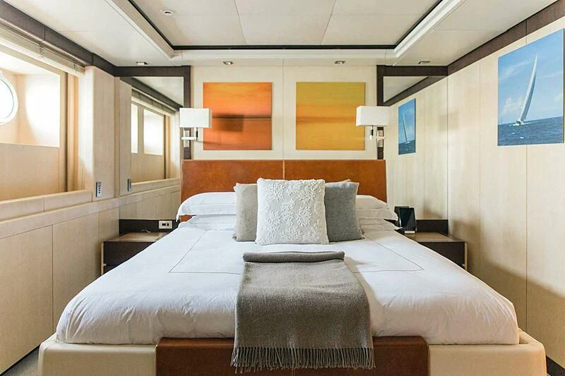 a bed with a white comforter aboard ALALYA Yacht for Sale
