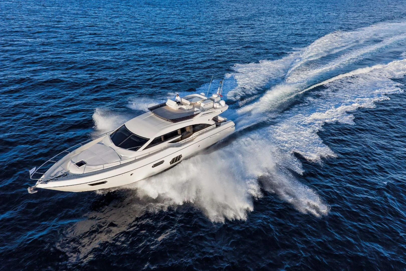 a white yacht on the water aboard FERRETTI Yacht for Sale