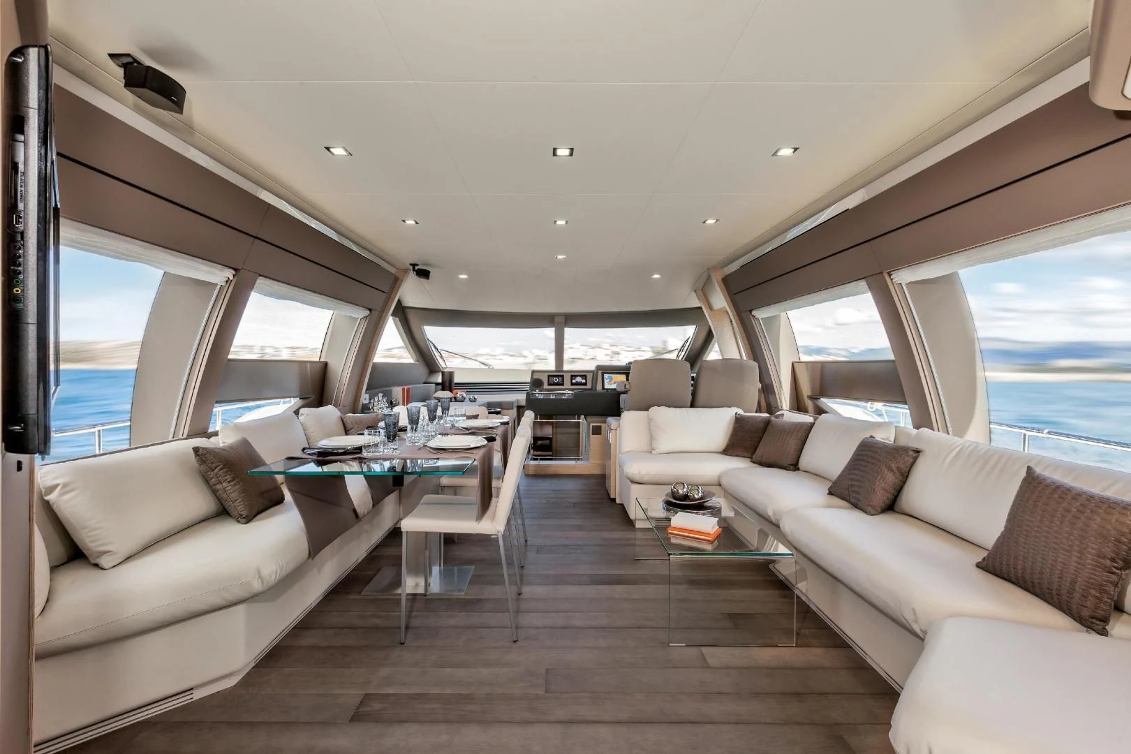 a living room with a large window aboard FERRETTI Yacht for Sale
