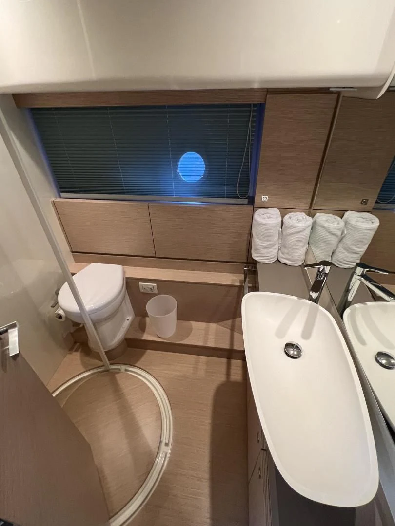 a bathroom with a tub sink and toilet aboard FERRETTI Yacht for Sale