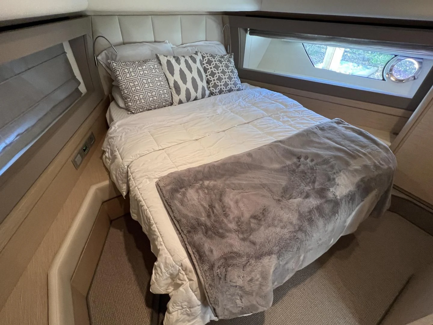 a bed with a television on the wall aboard FERRETTI Yacht for Sale
