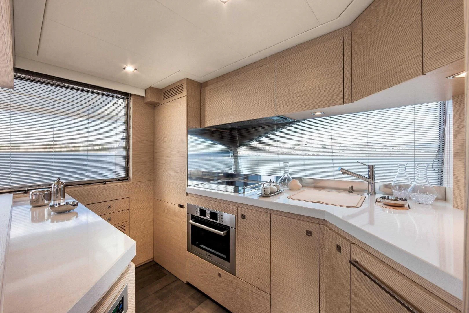a kitchen with wooden cabinets aboard FERRETTI Yacht for Sale