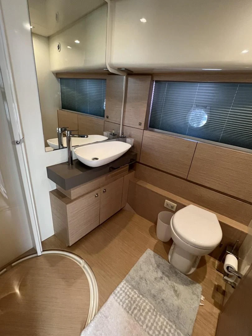 a bathroom with a sink and a toilet aboard FERRETTI Yacht for Sale