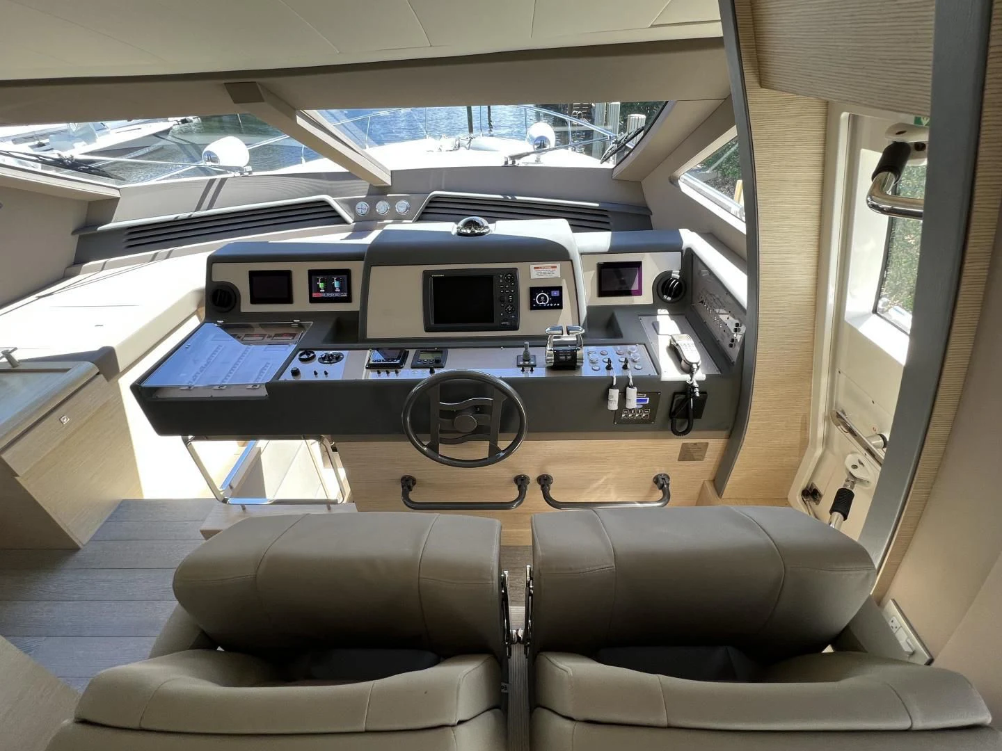 a room with a couch and a table with a computer on it aboard FERRETTI Yacht for Sale