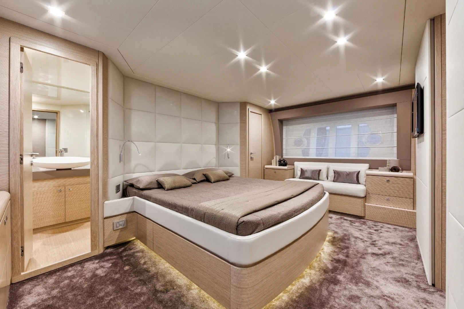 a room with a bed and a mirror aboard FERRETTI Yacht for Sale