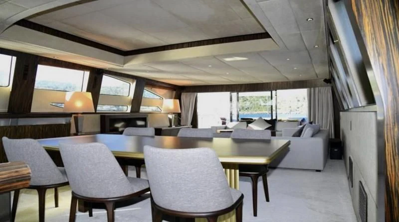 a room with a table and chairs aboard KAYANNI Yacht for Sale
