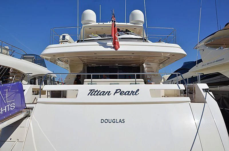 a white boat with a red stripe aboard THINK BIG Yacht for Sale