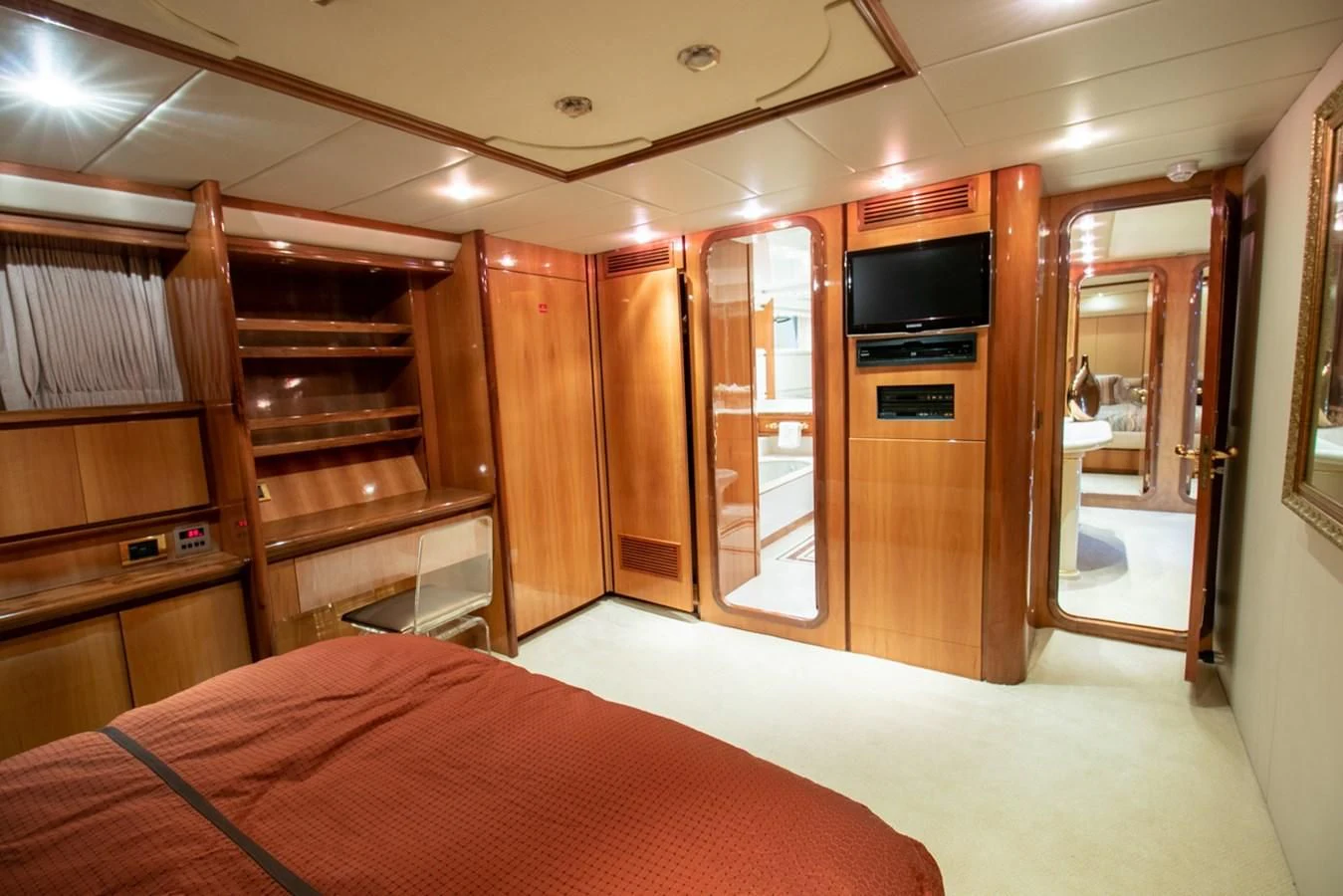 a bedroom with a bed and a tv aboard SHALIMAR Yacht for Sale