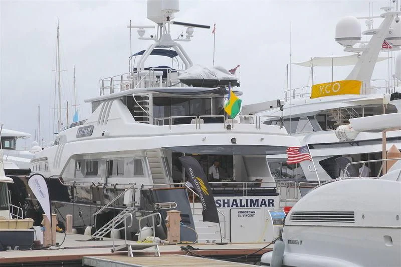 a boat with a flag on the deck aboard SHALIMAR Yacht for Sale