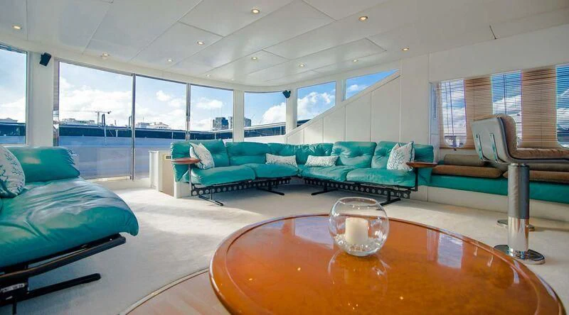 a living room with a table and chairs aboard SHALIMAR Yacht for Sale