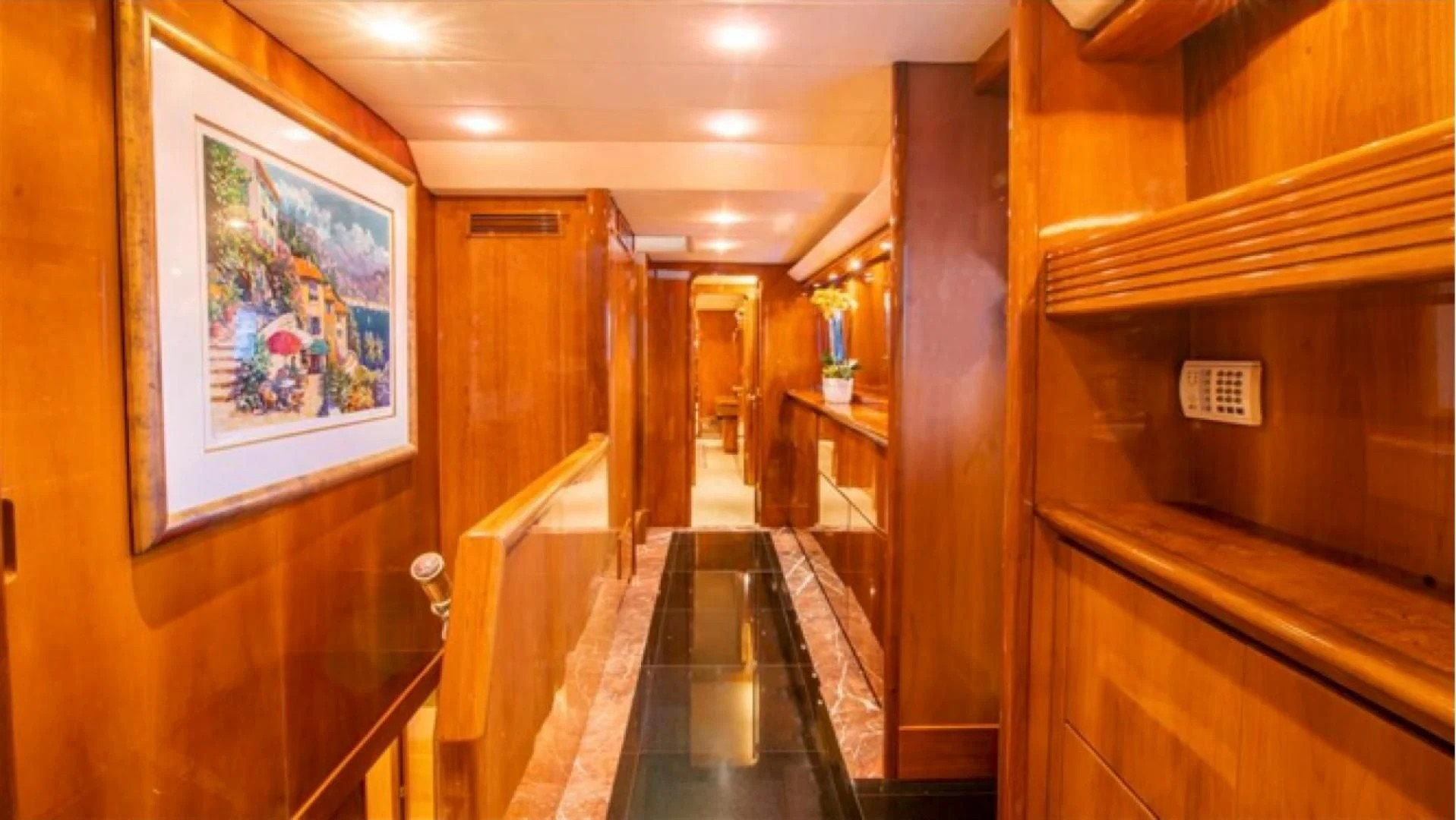 a hallway with a painting on the wall aboard SHALIMAR Yacht for Sale