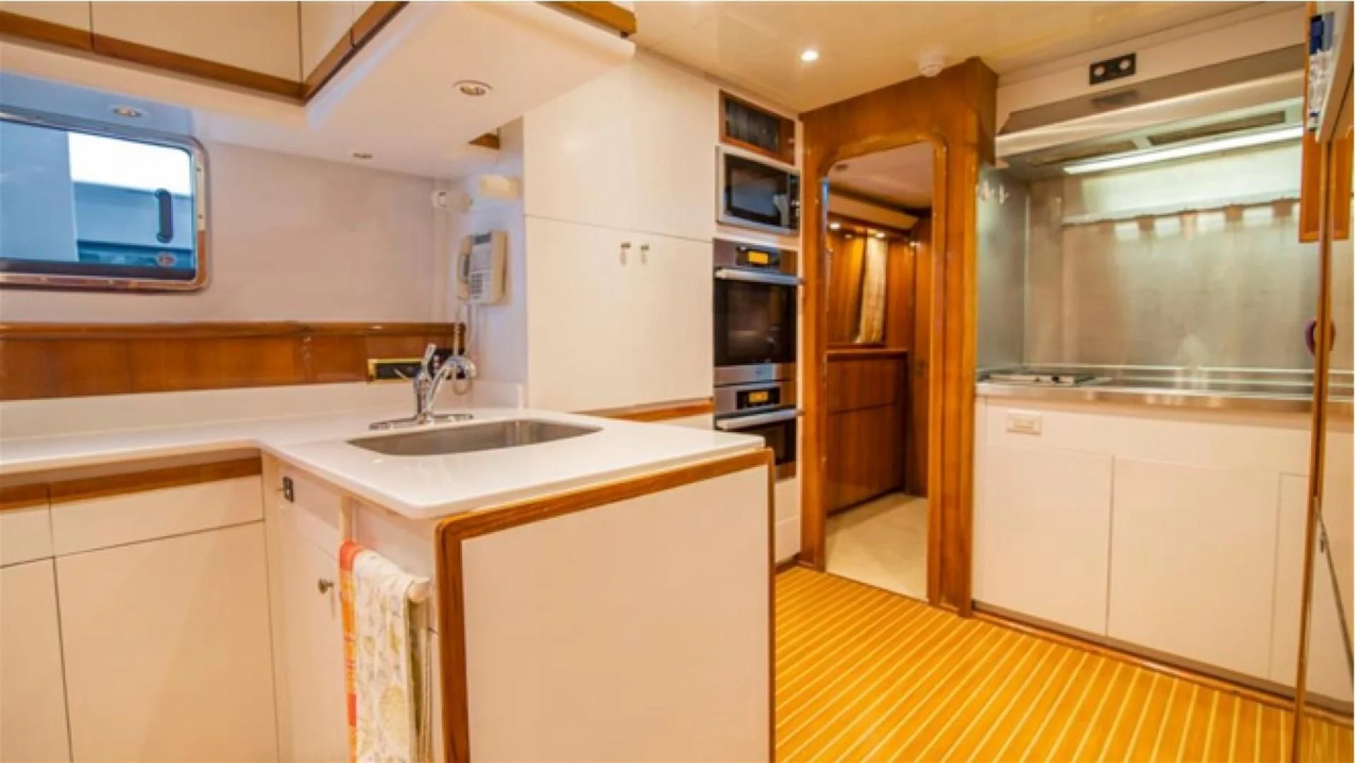 a kitchen with white cabinets aboard SHALIMAR Yacht for Sale