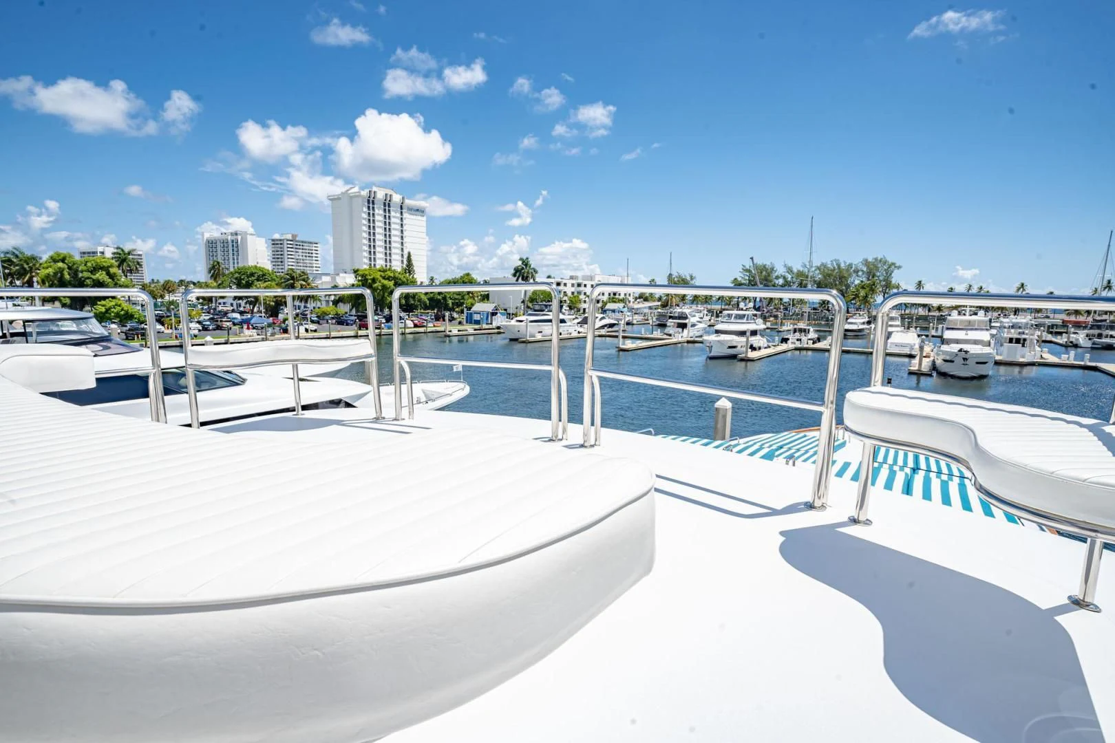 a large white pool with a city in the background aboard SHALIMAR Yacht for Sale