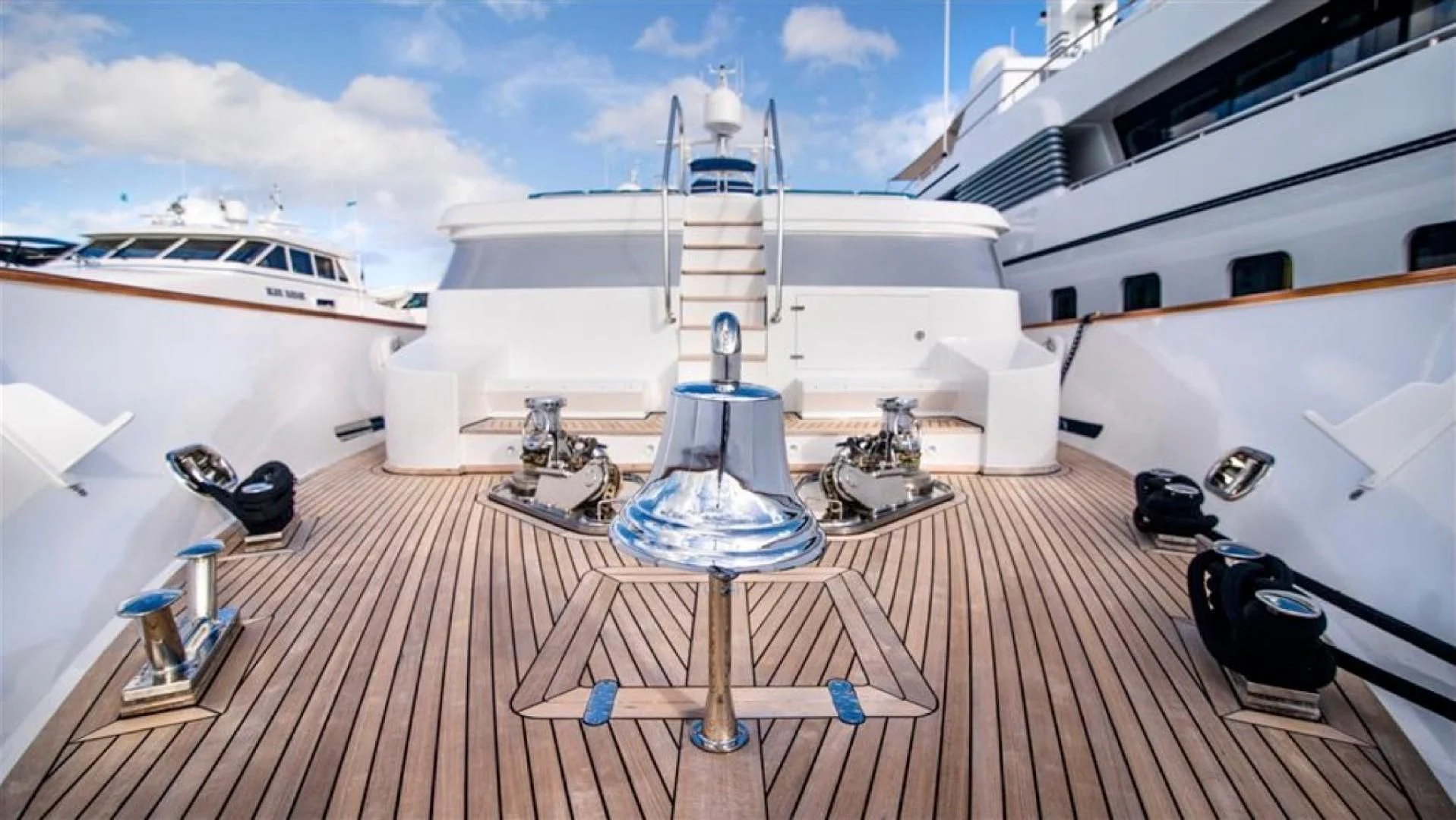 a deck with a deck and a large ship in the background aboard SHALIMAR Yacht for Sale