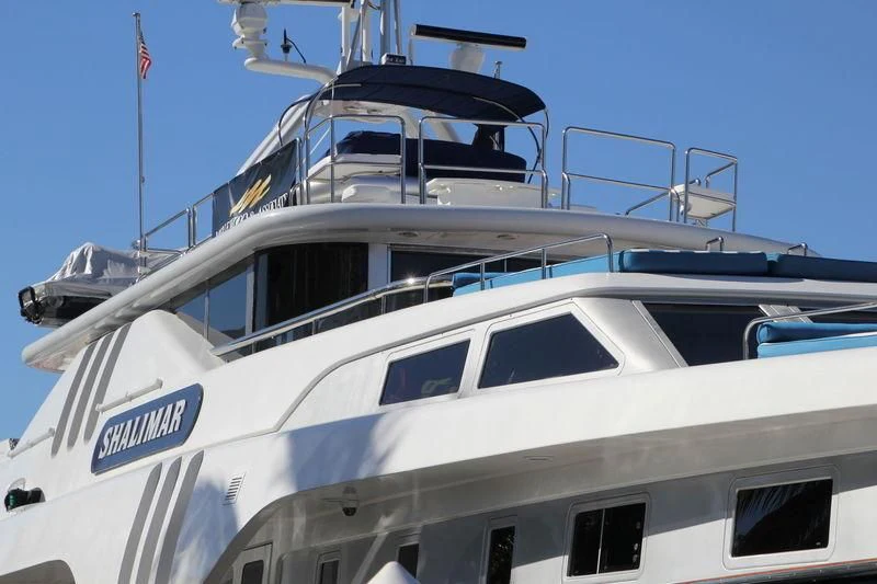 a boat with a flag on the front aboard SHALIMAR Yacht for Sale