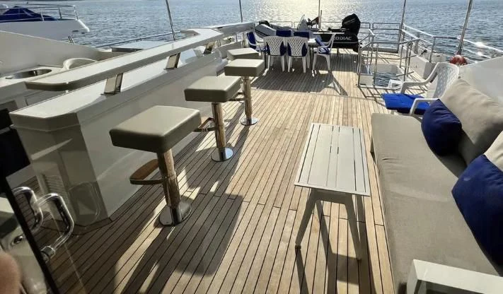 a deck with chairs and tables on it aboard HAPPY DAYS 1 Yacht for Sale