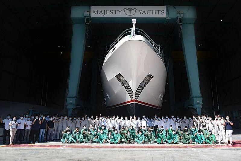 a group of people posing for a photo in front of a large round structure aboard HAPPY DAYS 1 Yacht for Sale