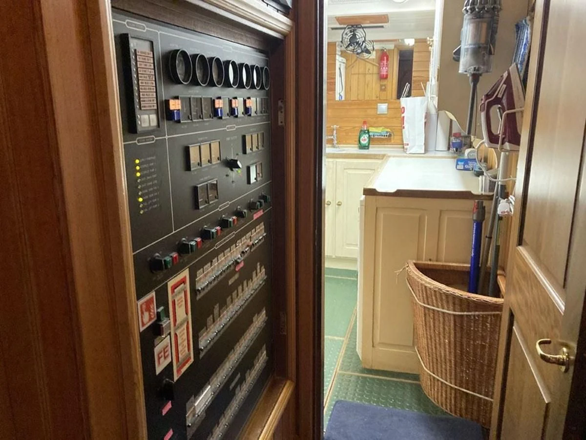 a small refrigerator with a large amount of magnets on it aboard TIGERLILY OF CORNWALL Yacht for Sale