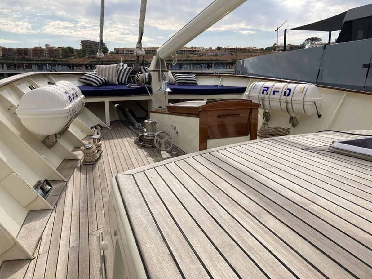 a deck with a deck and a large ship in the water aboard TIGERLILY OF CORNWALL Yacht for Sale