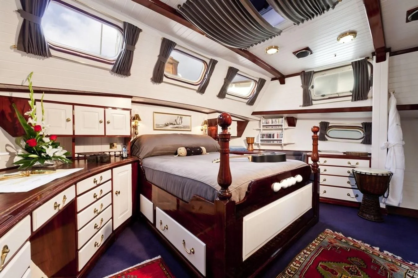 a bedroom with a bed and a piano aboard TIGERLILY OF CORNWALL Yacht for Sale