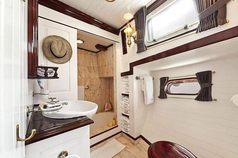 a bathroom with a sink and a mirror aboard TIGERLILY OF CORNWALL Yacht for Sale