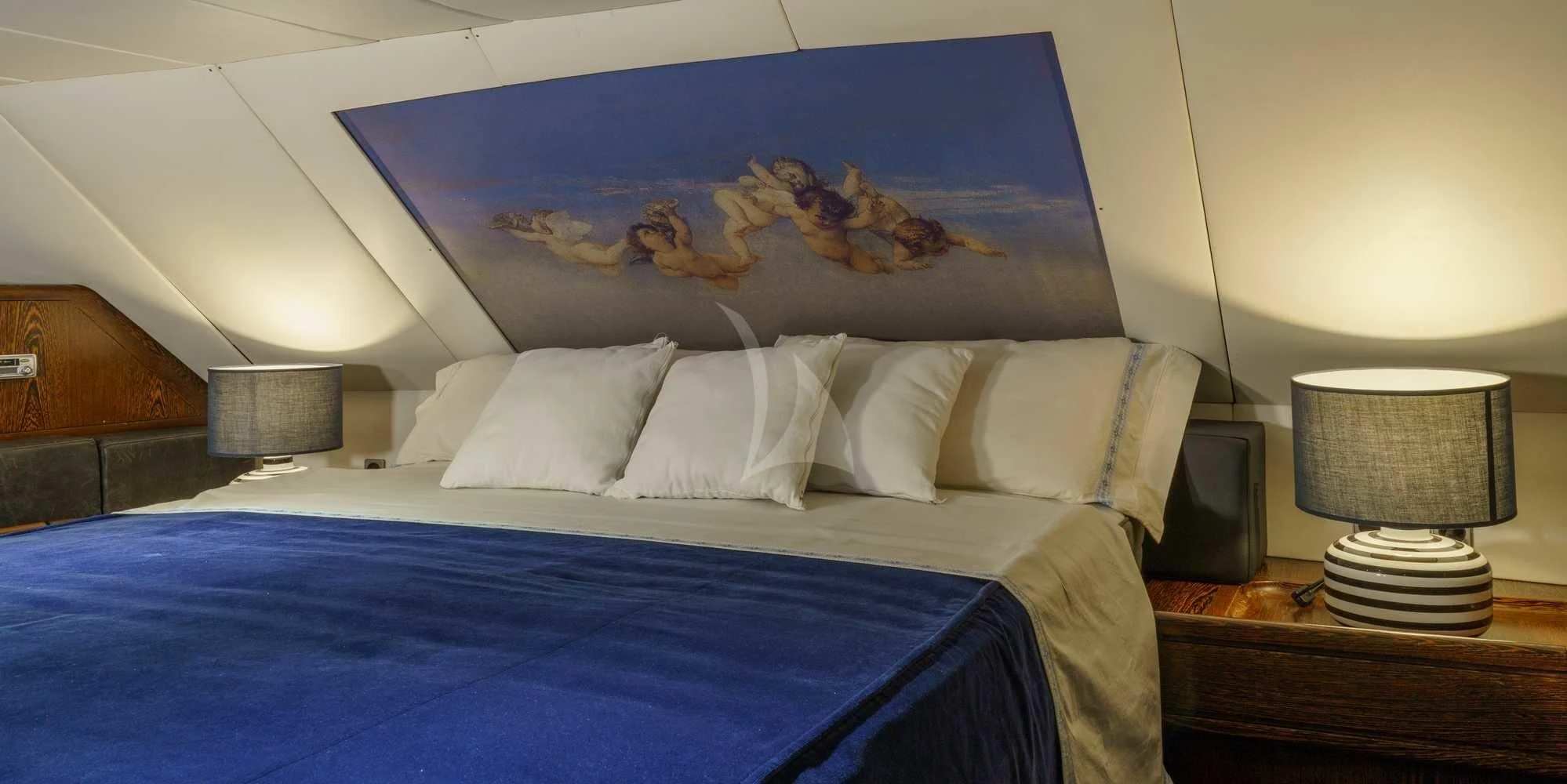 a bed with a blue sheet and a blue blanket aboard WHITE STAR OF RORC Yacht for Sale