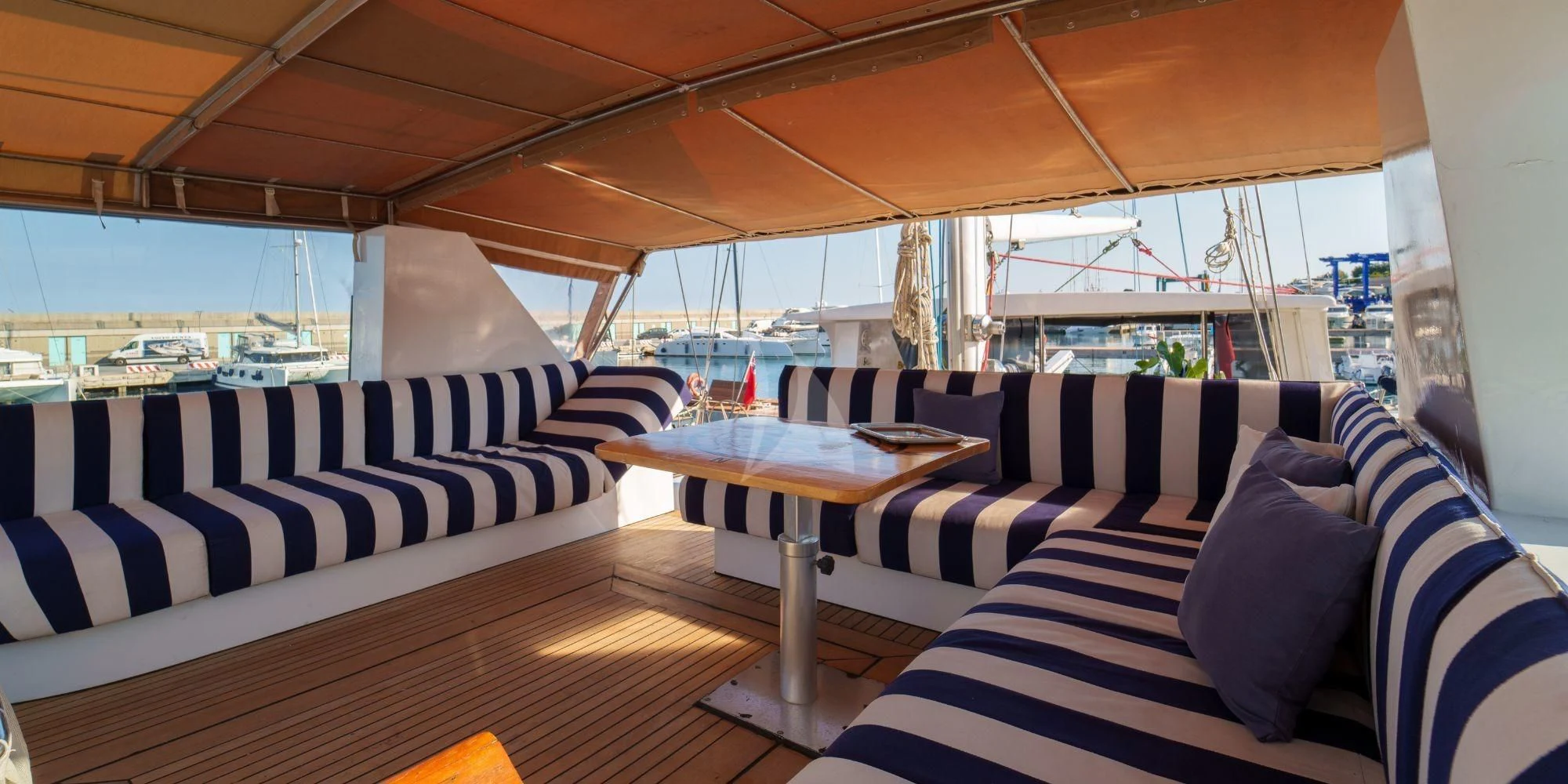 a boat with a table and chairs aboard WHITE STAR OF RORC Yacht for Sale
