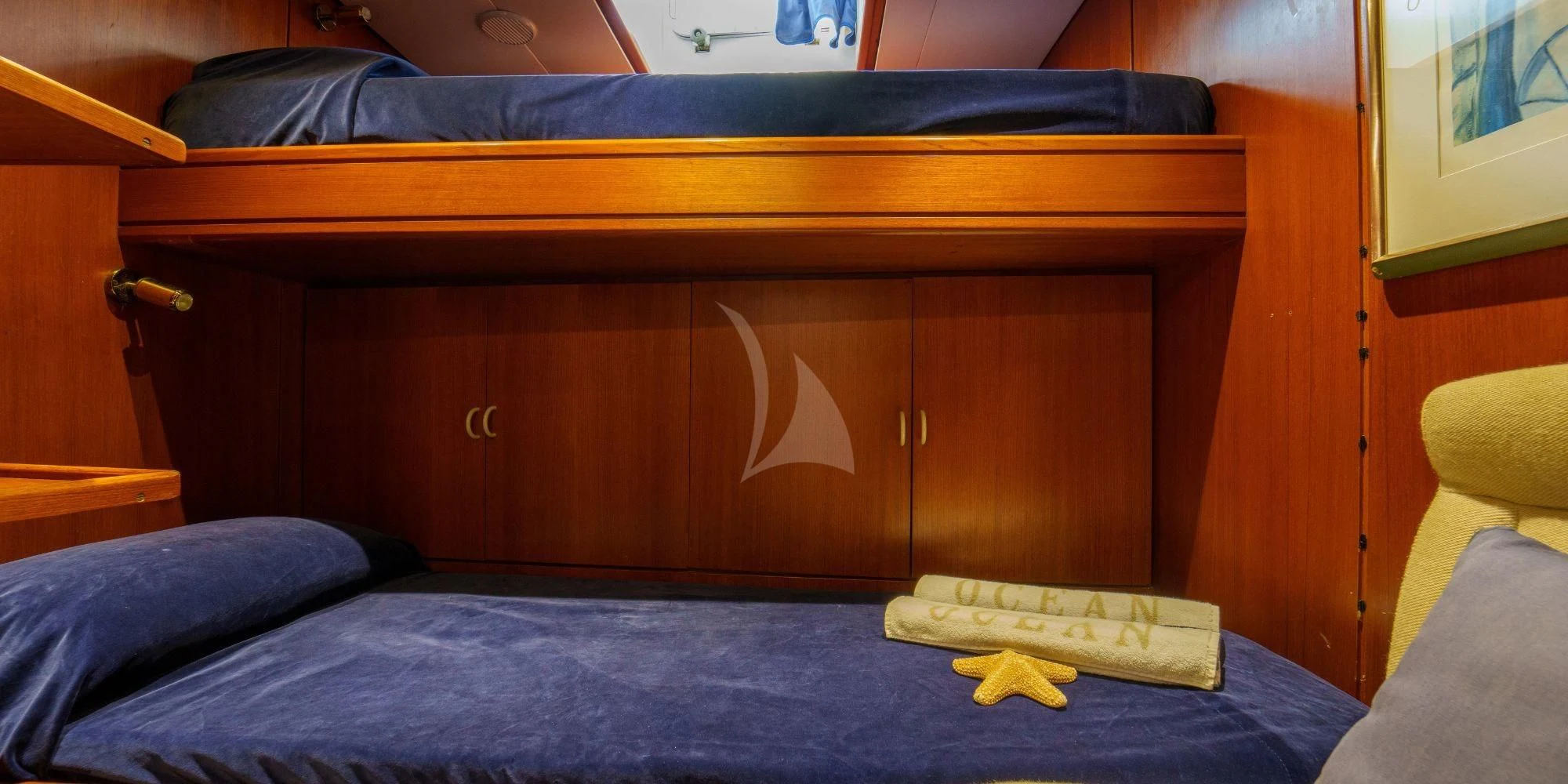 a bed with a wooden headboard aboard WHITE STAR OF RORC Yacht for Sale
