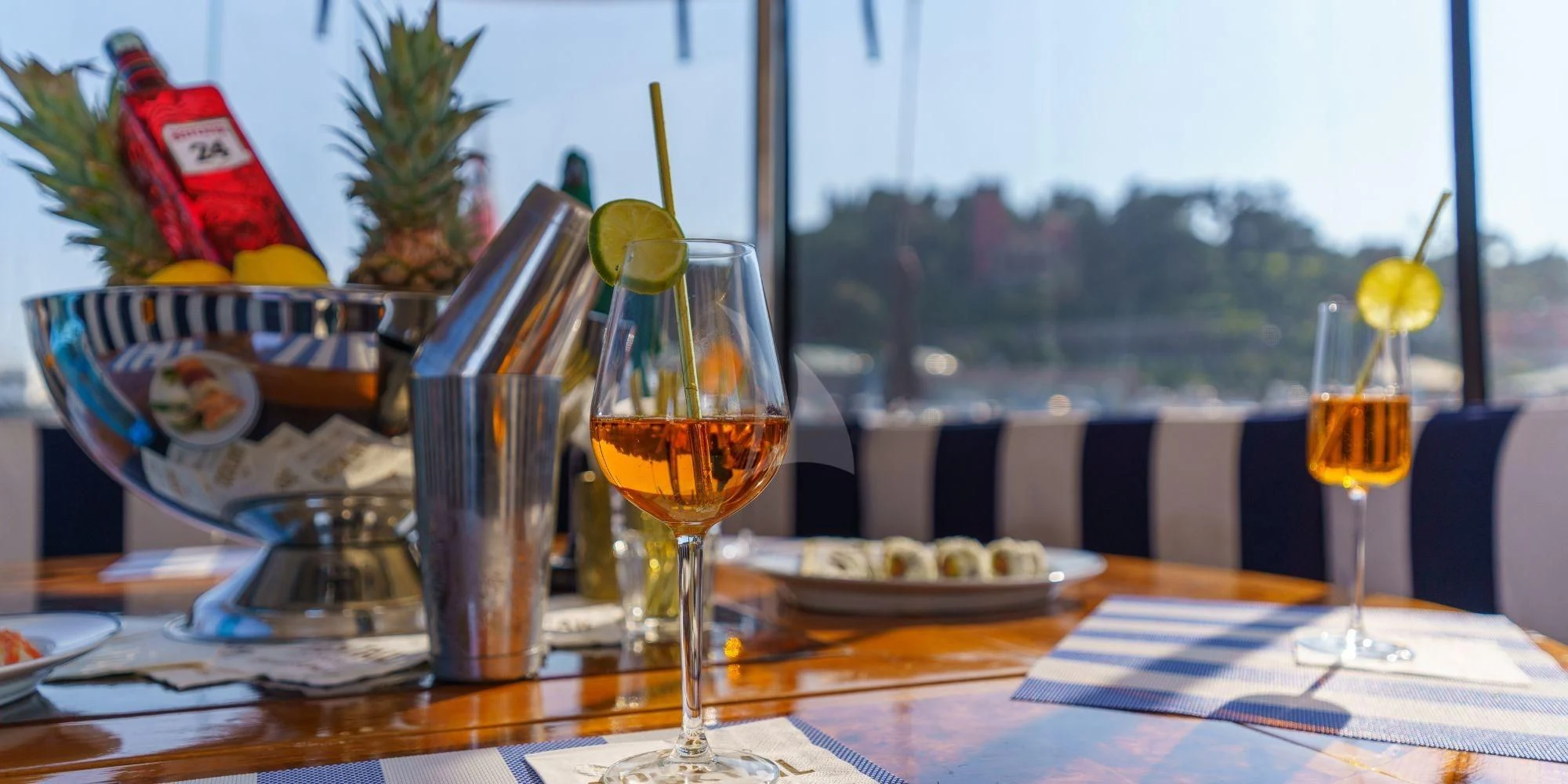 a table with glasses and food on it aboard WHITE STAR OF RORC Yacht for Sale