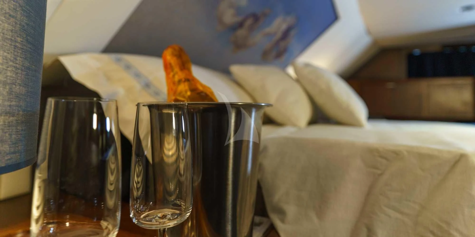 a glass of champagne and a slice of pizza on a table aboard WHITE STAR OF RORC Yacht for Sale