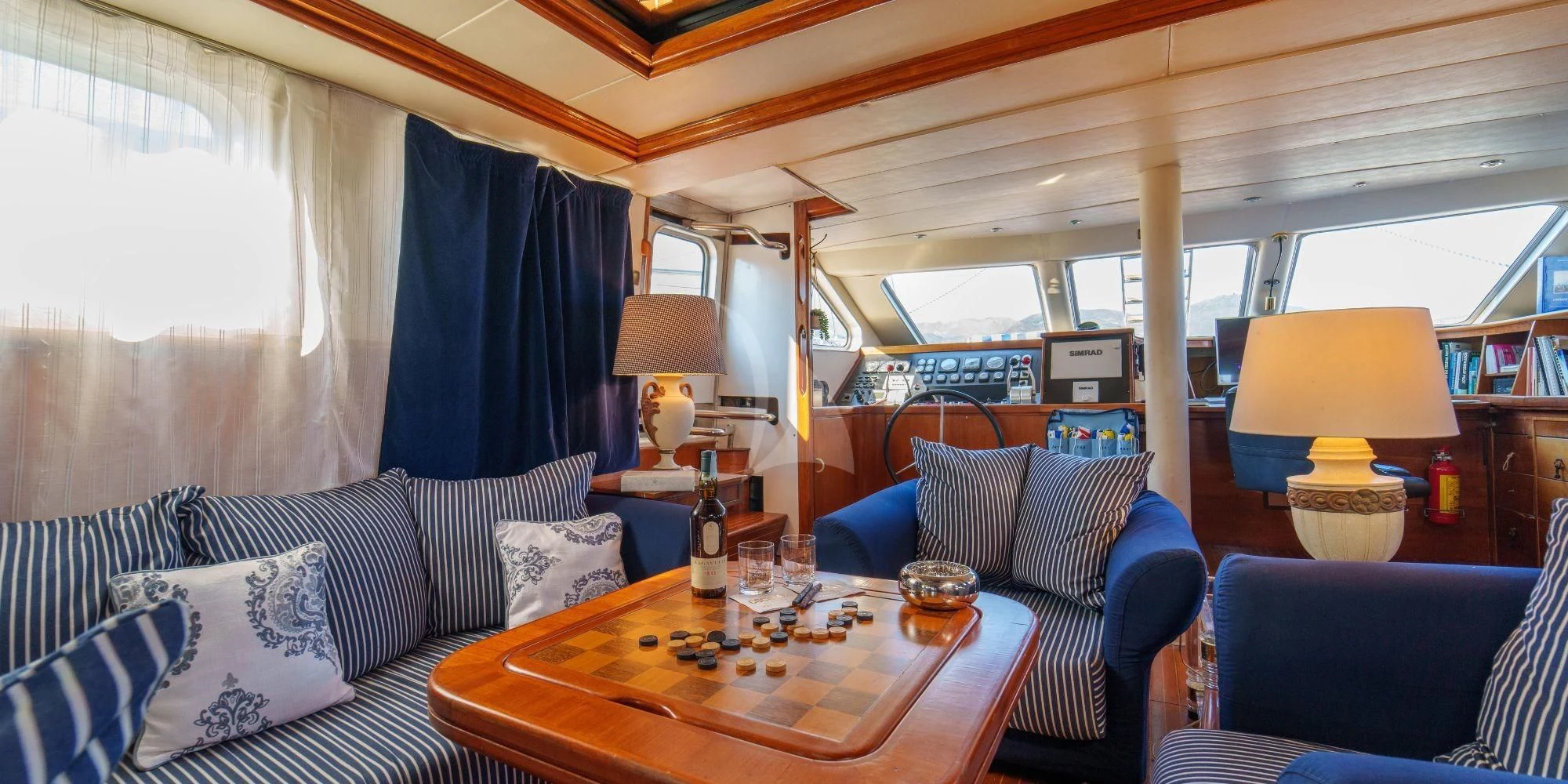 a living room with a table and couches aboard WHITE STAR OF RORC Yacht for Sale