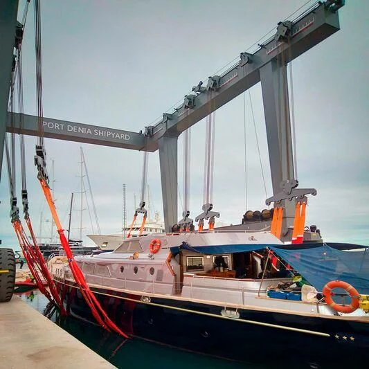 a boat with a red and white sail aboard PAZ Yacht for Sale