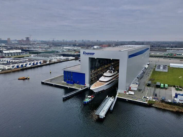a building with a dock and boats aboard JUICE Yacht for Sale