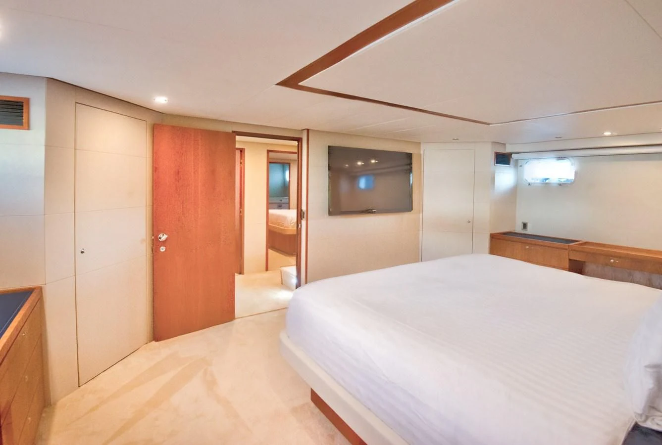 a room with a bed and a television aboard DESLIZE Yacht for Sale